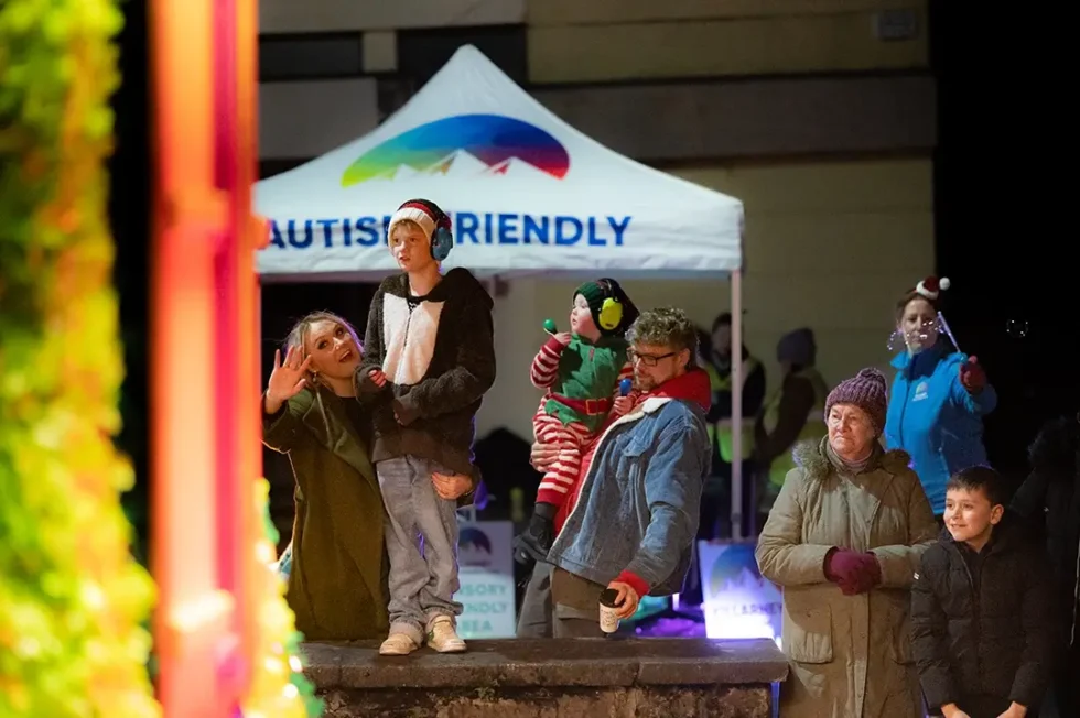 Mother and child with family members looking at Killarney Christmas Parade